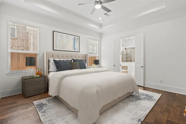 a bedroom with a large bed and a chandelier