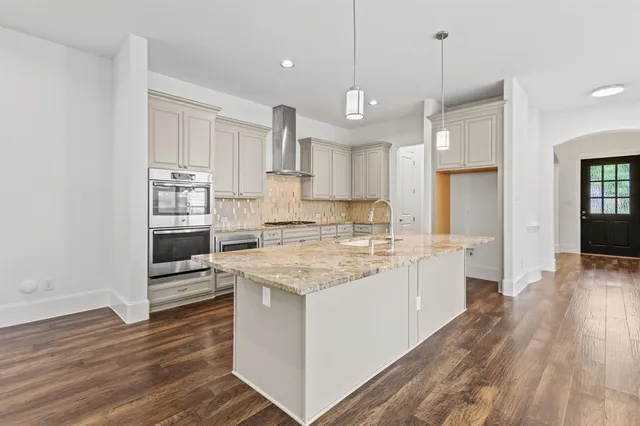 a kitchen with a stove a sink and a refrigerator