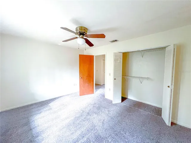 a view of a house with large windows and a small yard