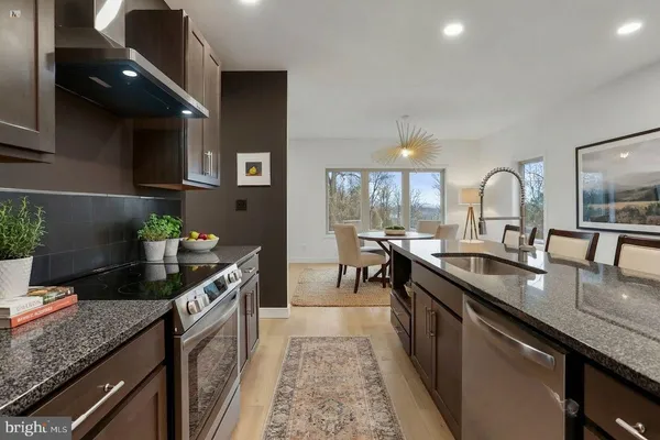 a large kitchen with a large counter top appliances and cabinets