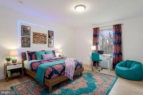 a bedroom with a bed and a wooden floor