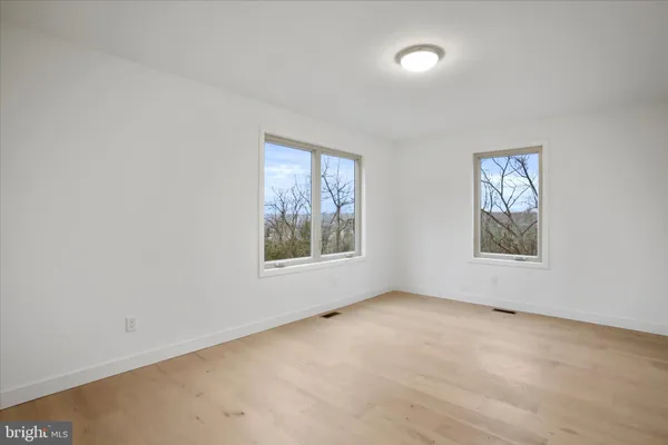 a living room with furniture a flat screen tv and a lamp