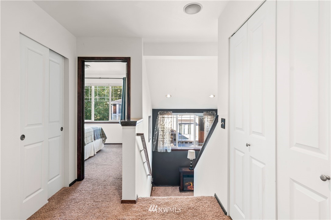 1626 93rd Place Southwest Everett, WA 98204 - Photo 12 of 25 a view of a hallway with wooden floor and a living room