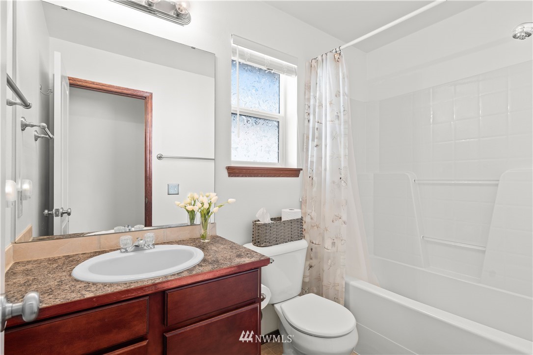 1626 93rd Place Southwest Everett, WA 98204 - Photo 15 of 25 a bathroom with a granite countertop sink toilet a mirror and shower