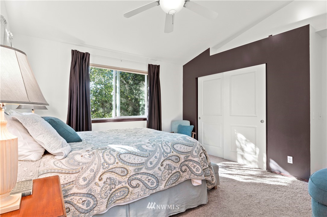 1626 93rd Place Southwest Everett, WA 98204 - Photo 18 of 25 a bedroom with a large bed and a large window