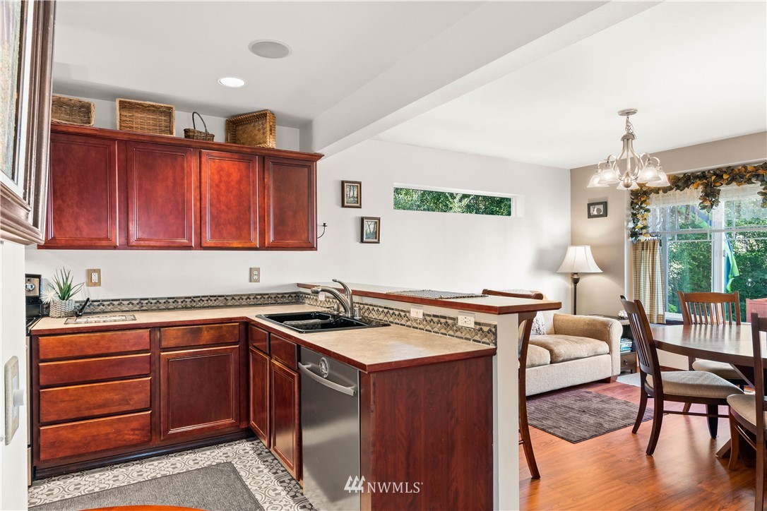1626 93rd Place Southwest Everett, WA 98204 - Photo 9 of 25 a kitchen with a stove a sink and cabinets