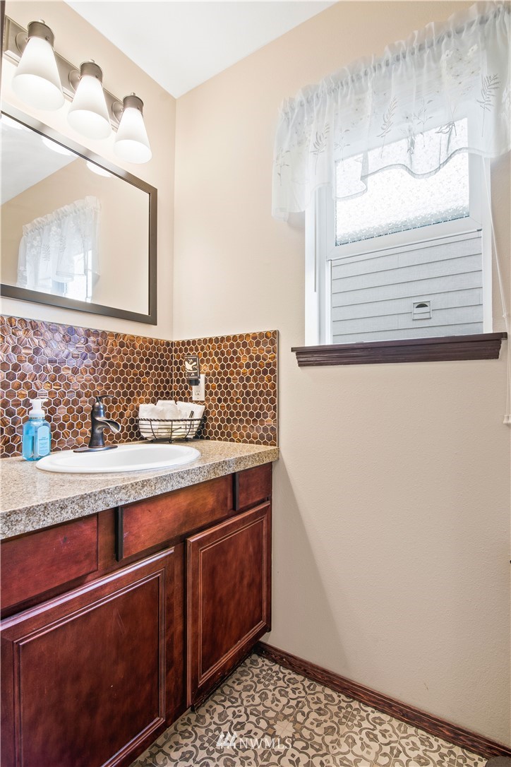 1626 93rd Place Southwest Everett, WA 98204 - Photo 10 of 25 a bathroom with a sink and a mirror