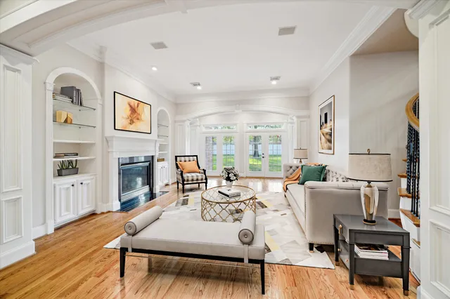 a living room with furniture a fireplace and a large window