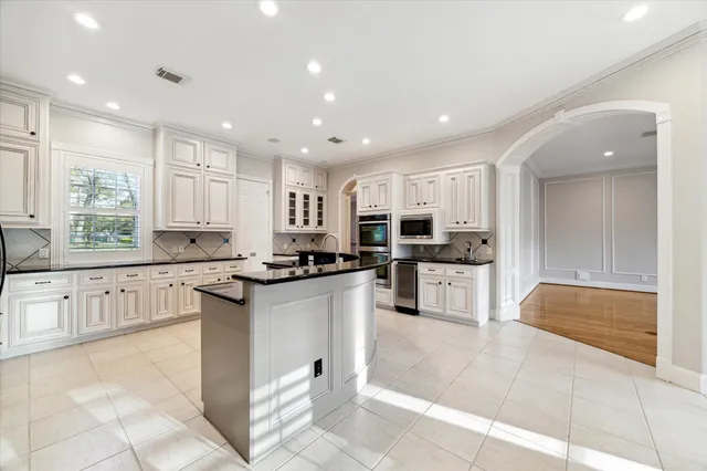 a kitchen with stainless steel appliances granite countertop a refrigerator and a sink