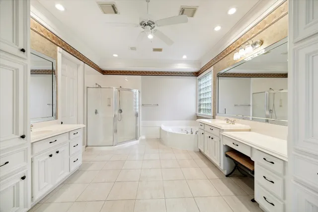 a large bathroom with a double vanity sink a large mirror and a shower