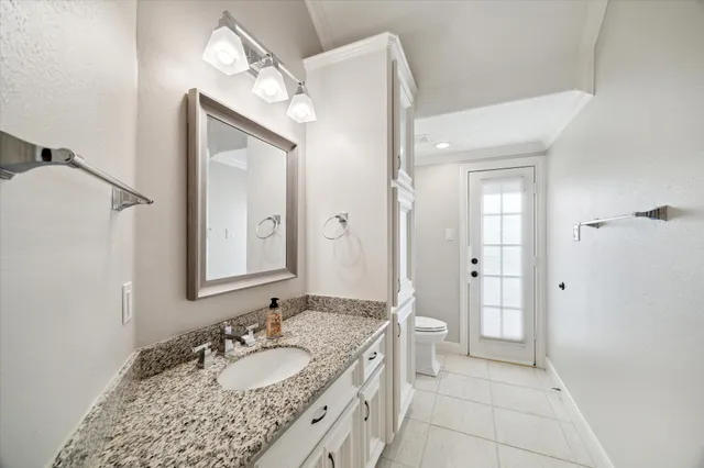 a bathroom with a granite countertop sink a mirror and a shower