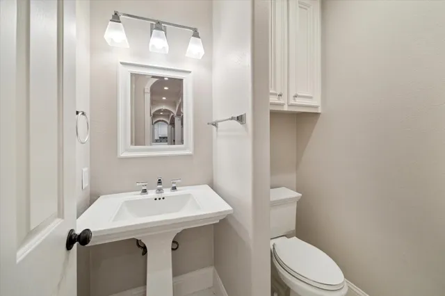 a bathroom with a sink a mirror and a toilet