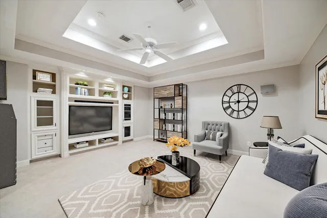 a living room with furniture a flat screen tv and a large window