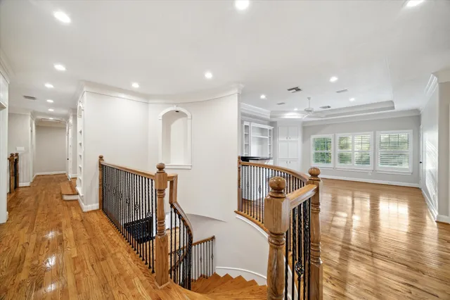 a view of a room with wooden floor and windows