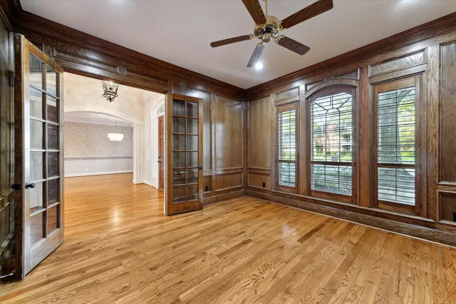 a view of an empty room with window and wooden floor