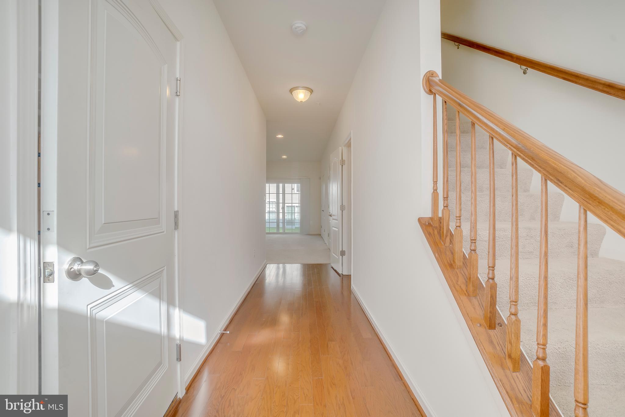 972 Winter Run Road Baltimore, MD 21220 - Photo 6 of 23 a view of a hallway with wooden floor and staircase
