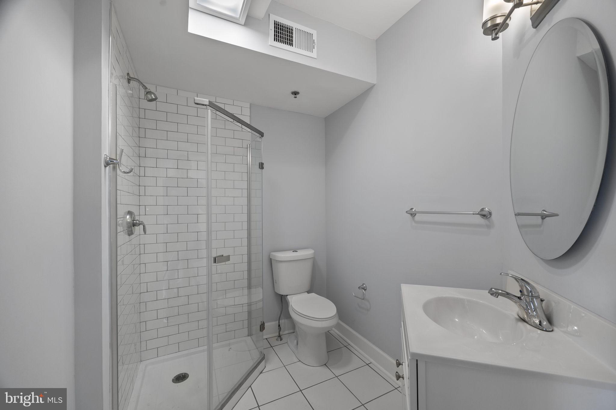 180 Main Street, Unit 202 Annapolis, MD 21401 - Photo 14 of 17 a bathroom with a sink toilet and shower
