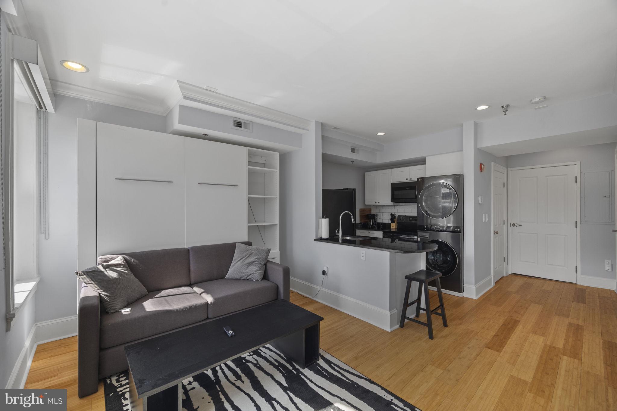 180 Main Street, Unit 202 Annapolis, MD 21401 - Photo 2 of 17 a living room with furniture and a stove top oven
