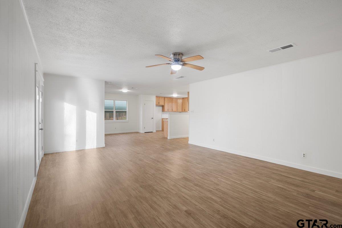 585 Highway 149 Tatum, TX 75691 - Photo 12 of 45 wooden floor in an empty room with a window