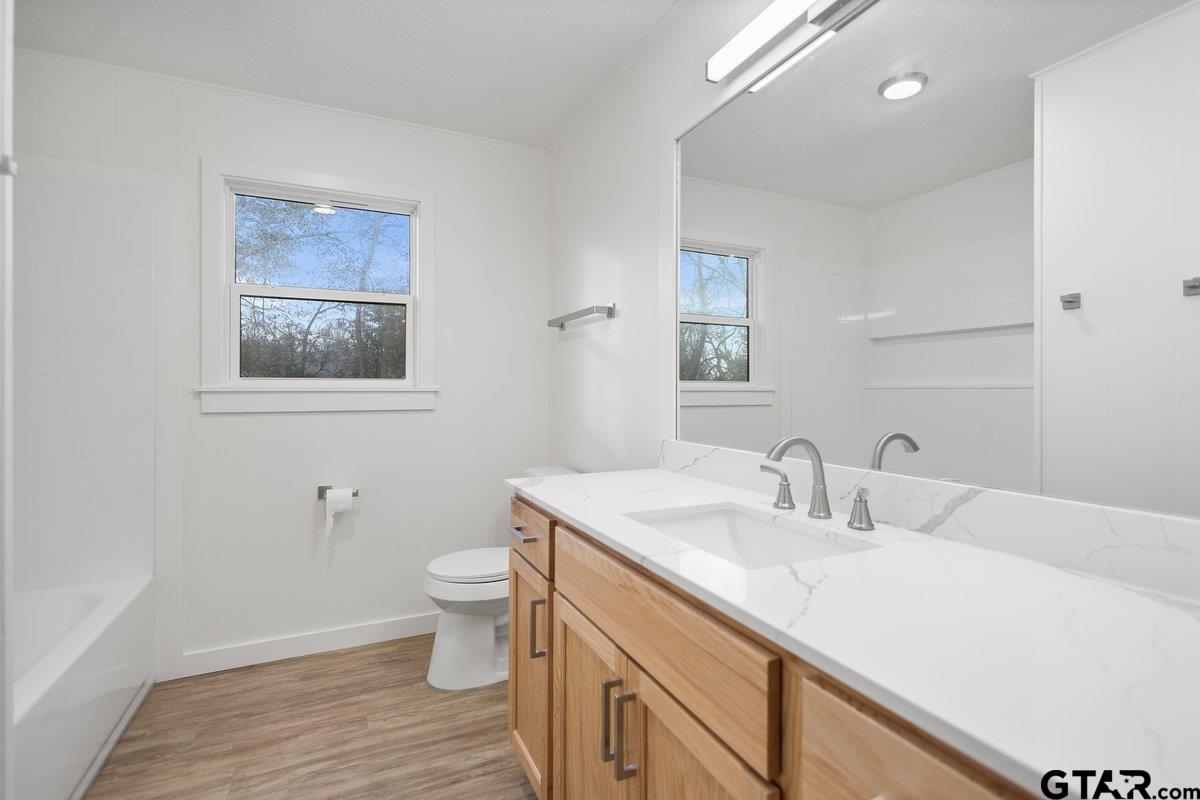 585 Highway 149 Tatum, TX 75691 - Photo 15 of 45 a bathroom with a sink and a toilet