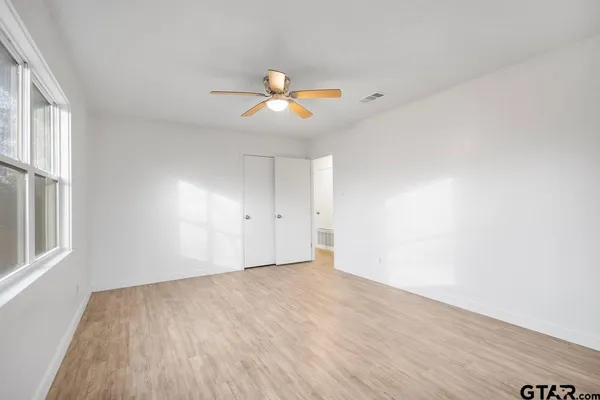 wooden floor in an empty room with a window