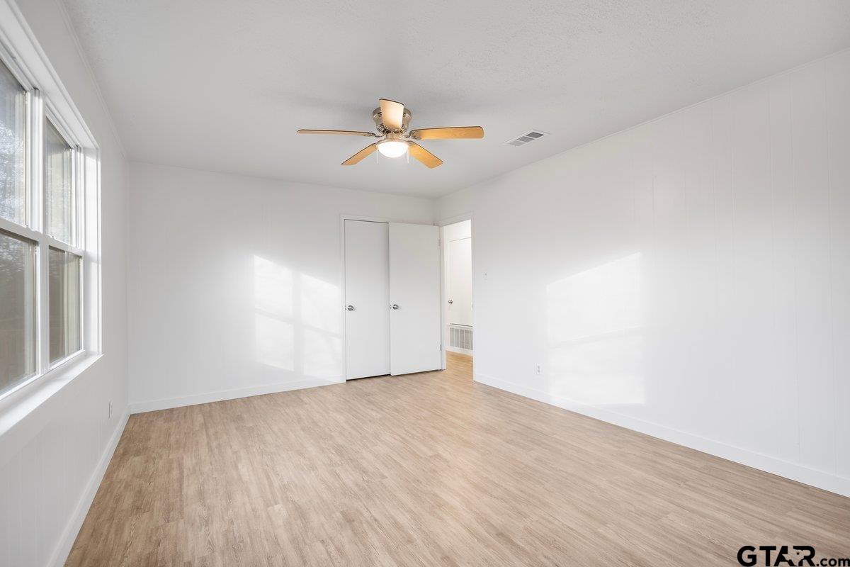 585 Highway 149 Tatum, TX 75691 - Photo 19 of 45 wooden floor in an empty room with a window