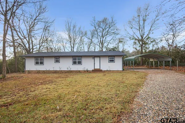 a front view of house with yard and trees