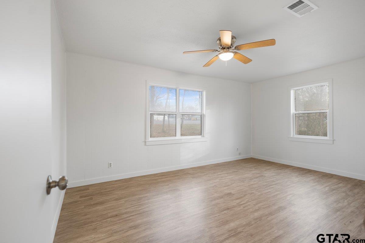 585 Highway 149 Tatum, TX 75691 - Photo 22 of 45 wooden floor in an empty room with a window