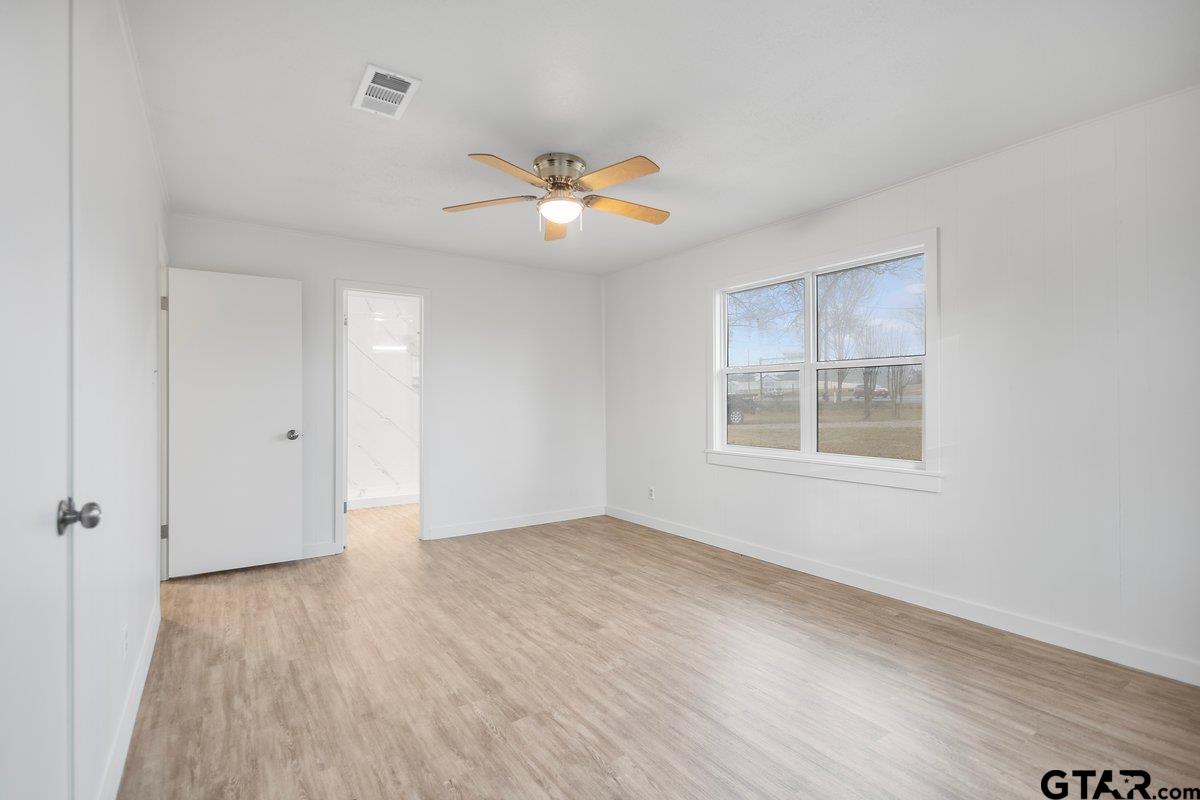 585 Highway 149 Tatum, TX 75691 - Photo 23 of 45 wooden floor in an empty room with a window