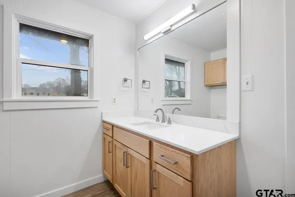 a bathroom with a sink a vanity and a mirror