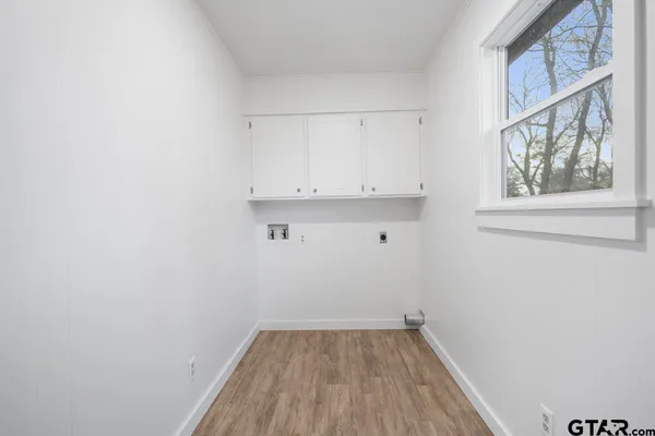 a view of small space with wooden floor and a window