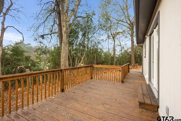 a view of balcony with wooden floor and fence