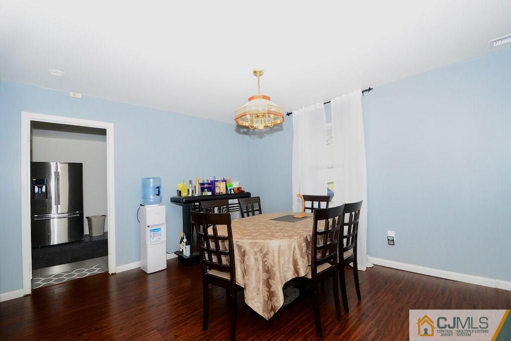 135 Drake Road Somerset, NJ 08873 - Photo 4 of 16 a view of a dining room with furniture wooden floor and chandelier