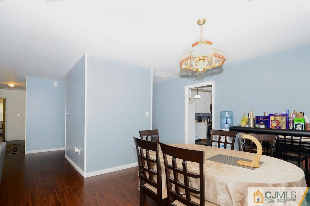 135 Drake Road Somerset, NJ 08873 - Photo 5 of 16 a view of a dining room with furniture wooden floor and chandelier