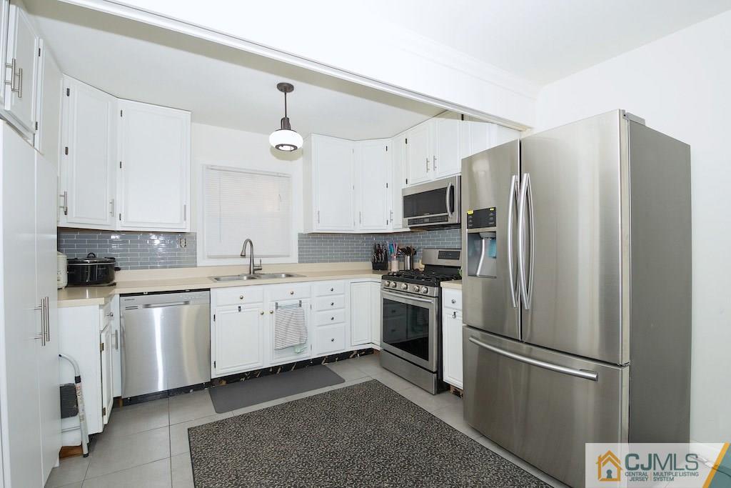 135 Drake Road Somerset, NJ 08873 - Photo 6 of 16 a kitchen with stainless steel appliances a refrigerator sink and microwave