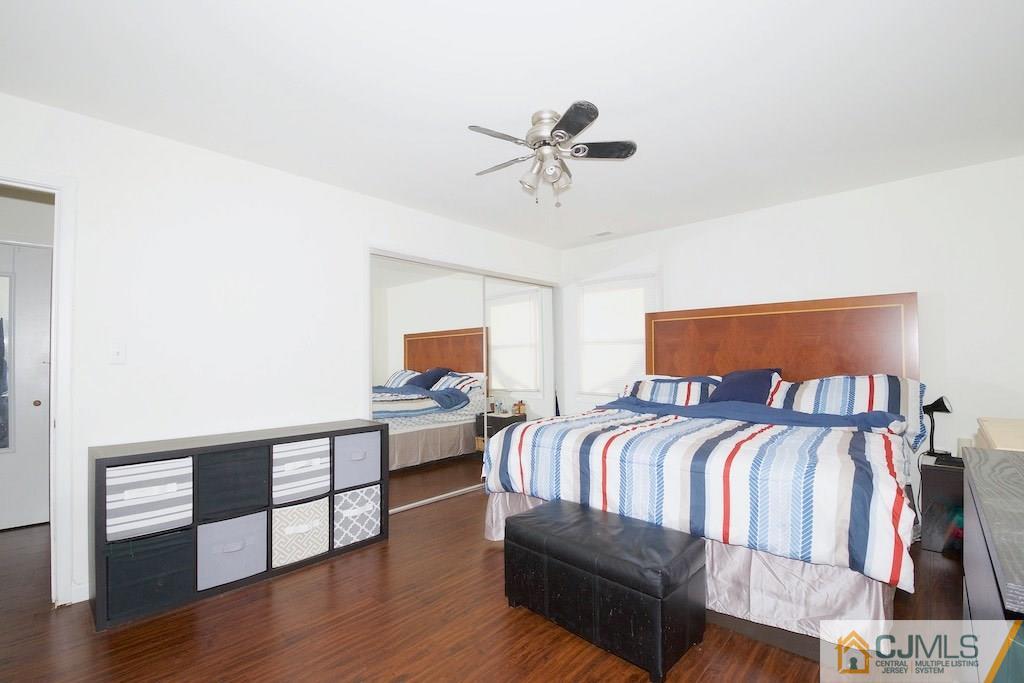 135 Drake Road Somerset, NJ 08873 - Photo 8 of 16 a bedroom with a bed and wooden floor