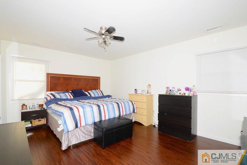 135 Drake Road Somerset, NJ 08873 - Photo 9 of 16 a bedroom with a bed and wooden floor