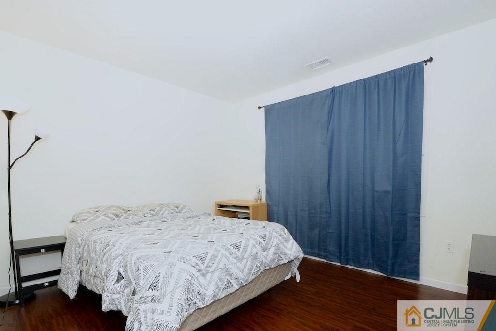135 Drake Road Somerset, NJ 08873 - Photo 10 of 16 a bedroom with a bed and wooden floor