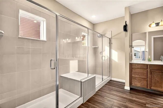 a bathroom with a double vanity sink toilet and shower