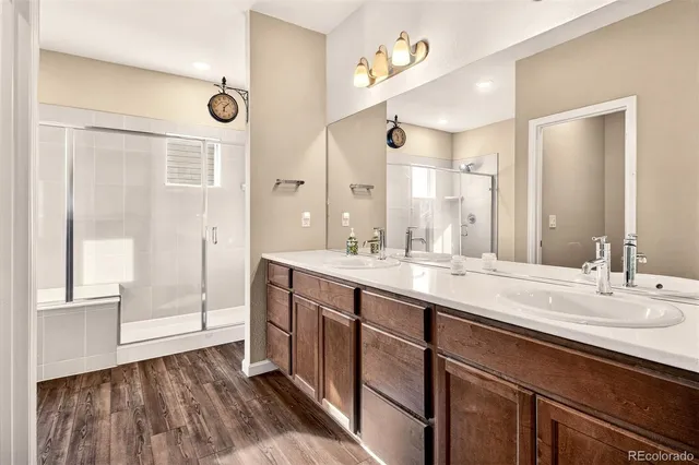 a bathroom with a double vanity sink and a mirror