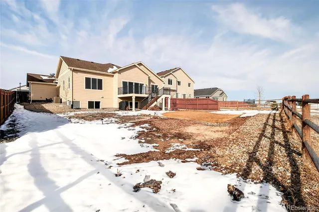 a view of a house with a yard covered in snow