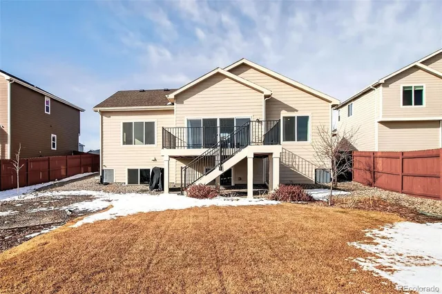 a view of a house with wooden fence