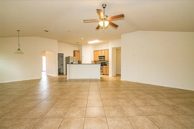 a view of a kitchen with a sink and a chandelier fan
