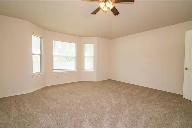 an empty room with a empty space and a window