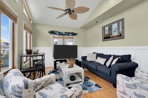 a living room with furniture a ceiling fan and a fireplace