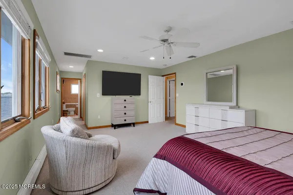 a bedroom with furniture and a flat screen tv