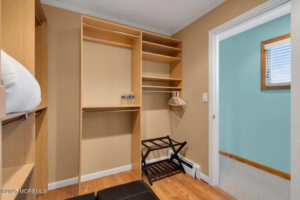 a view of a room with wooden floor and bathroom