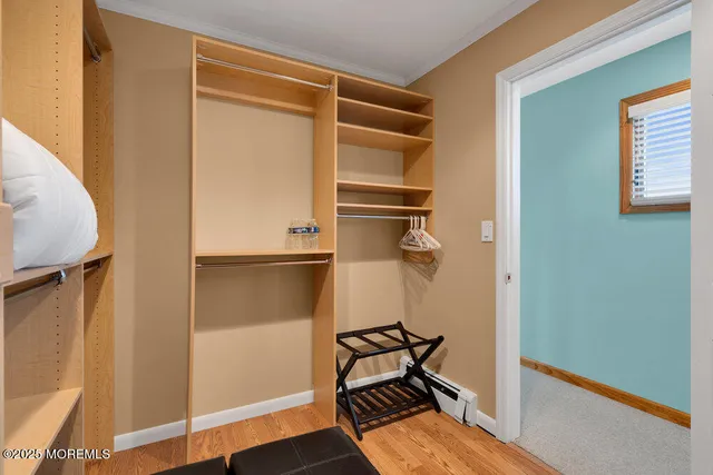 a view of a room with wooden floor and bathroom