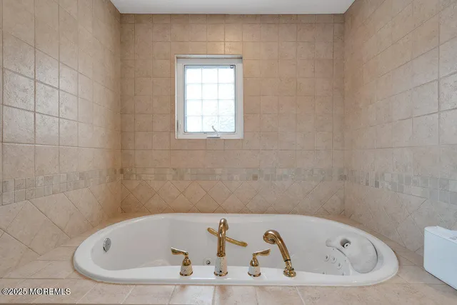a white bath tub sitting in a bathroom