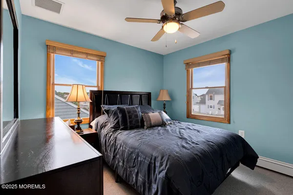 a bed sitting in a bedroom next to a window